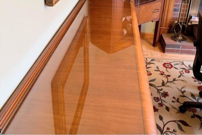 Clear glass tabletop protecting a vintage wood heirloom desk.