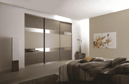 Bronze mounted mirrors on closet door in beige room