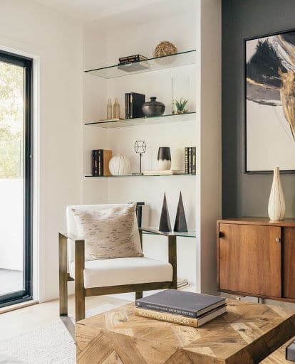 Living room featuring custom glass shelves