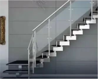Glass stair railing with modern black stairs, against a grey wall in the background