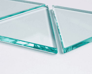 Close-up of custom tempered glass pieces with beveled edges, suitable for shower doors, table tops, and mirrors.