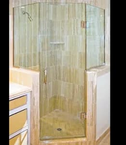 Custom shower doors featuring tempered glass with a beveled glass edge, integrated into a modern bathroom design.