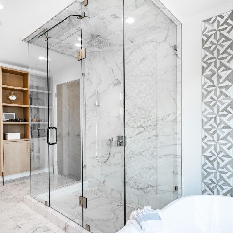 A contemporary bathroom with a see-through corner shower door with steam feature.