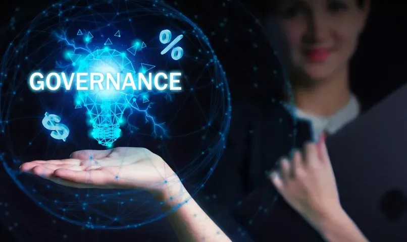 Conceptual image of governance illustrated with a glowing hand holding a light bulb, highlighting ideas of custom glass solutions like shower doors, table tops, mirrors, tempered glass, and beveled glass edges.