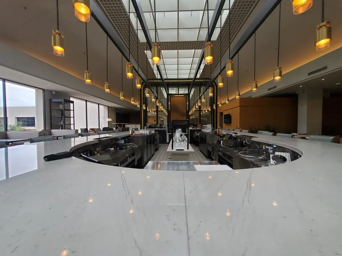 Modern restaurant interior featuring custom glass bar tops, tempered glass fixtures, and stylish lighting.