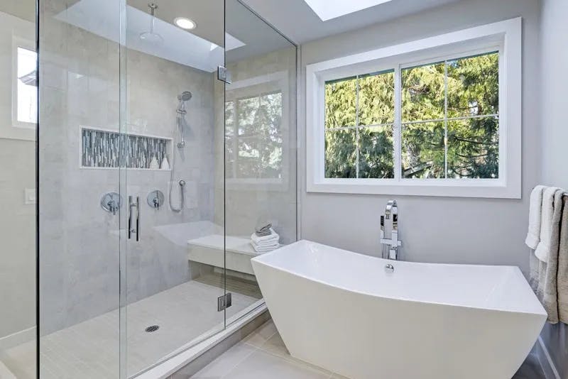 bright-bathroom-with-a-corner-shower-door-next-to-a-white-bathtub