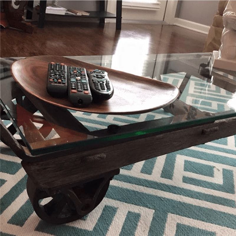 An elegant glass coffee table featuring a convenient wheeled cart for easy mobility