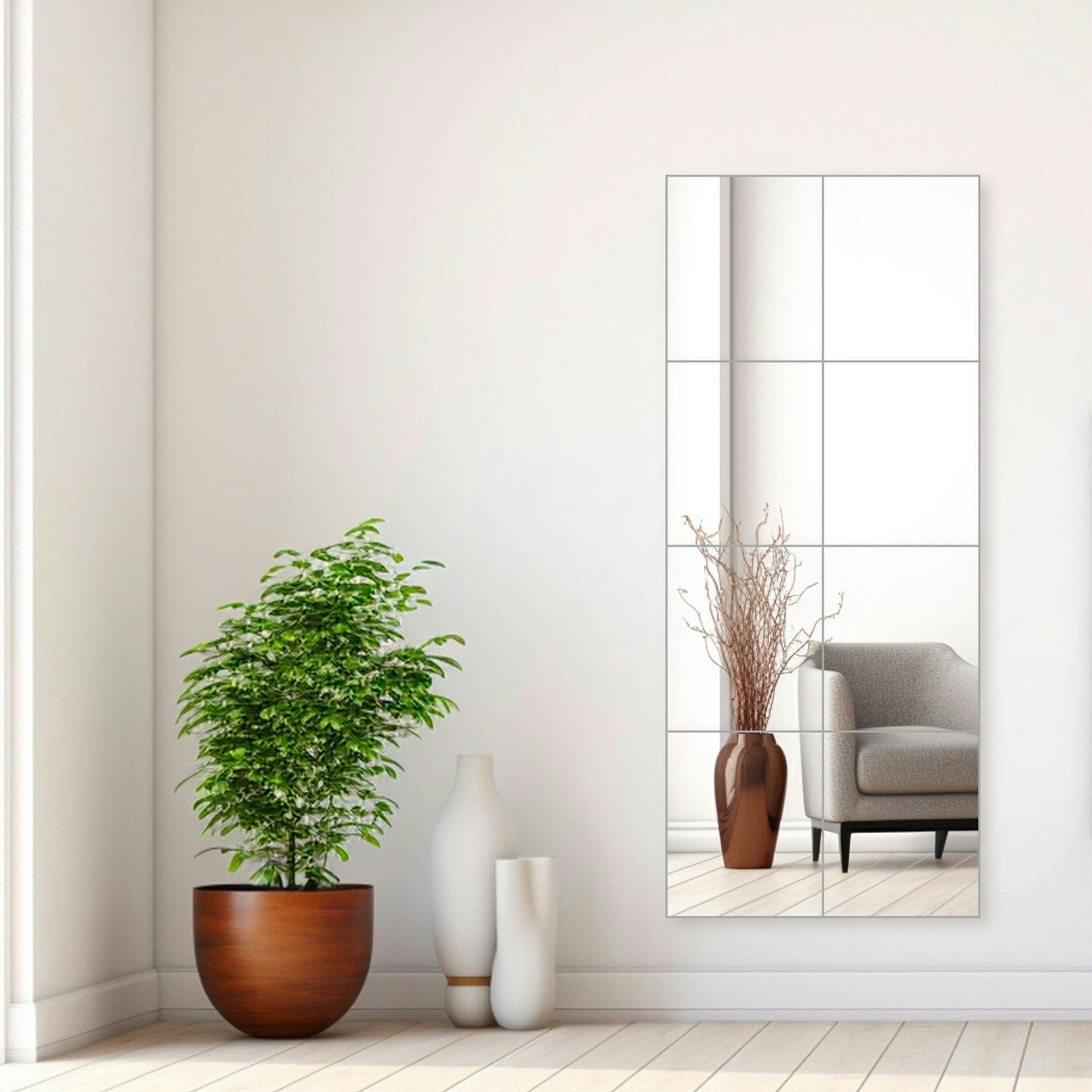 8 piece wall mirror tiles in a living room environment next to white vases and a green pottery plant