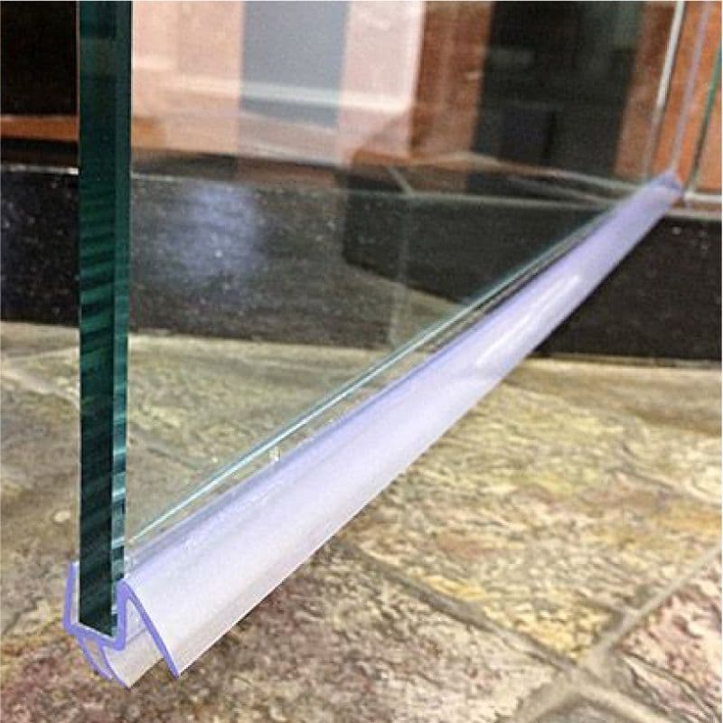 Close-up of a clear tempered glass edge with a silicone seal, ideal for custom glass shower doors, table tops, and mirrors, featuring a beveled glass edge for a polished finish.