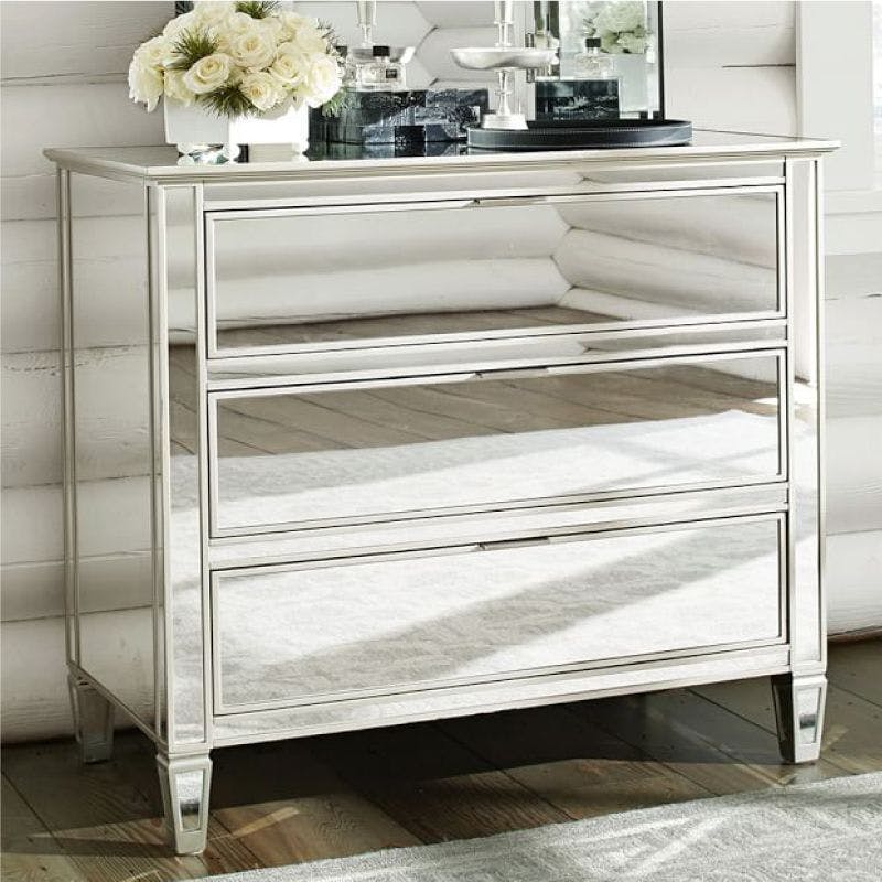 A mirrored nightstand with three drawers, perfect for storing and organizing your belongings
