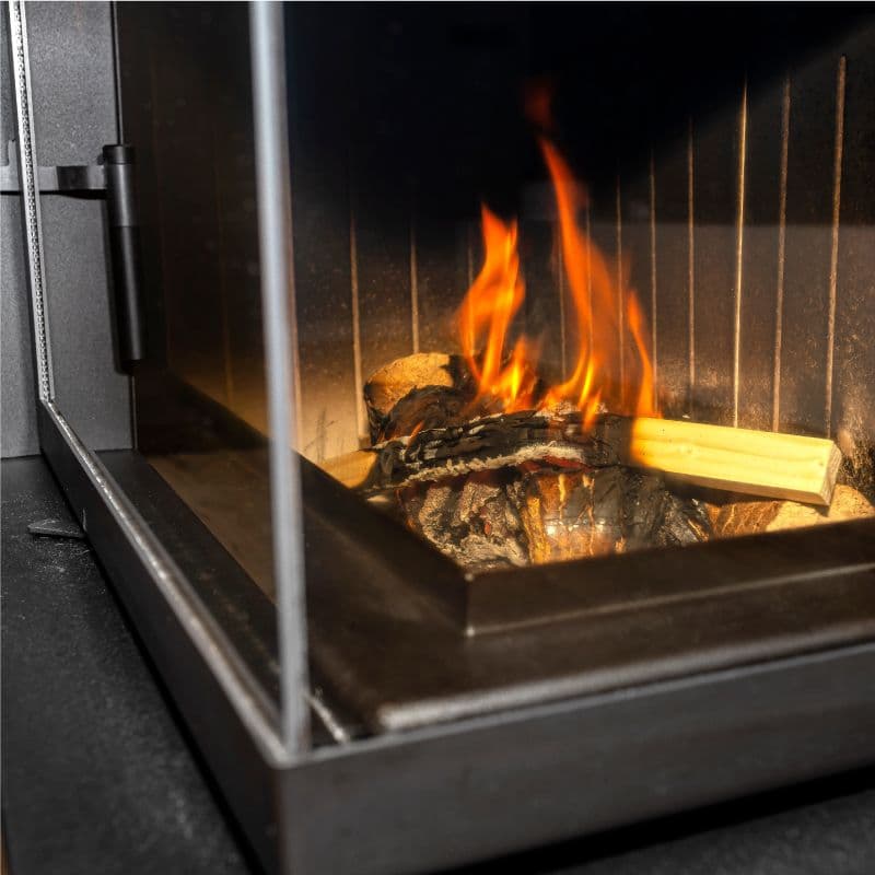 Custom glass application in a modern fireplace featuring tempered glass and a clean design, showcasing the beauty of glass elements in home interiors.
