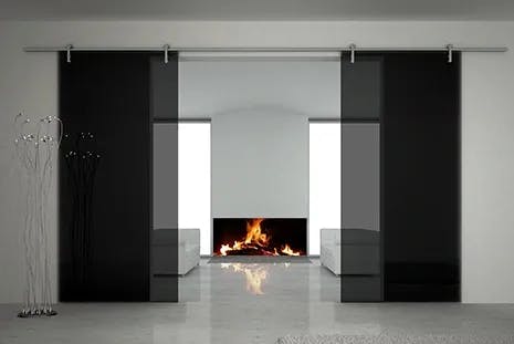 gray tinted glass sliding barn doors infront of large fireplace