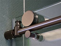 sliding shower door glider system in bronze color finish on glass shower door