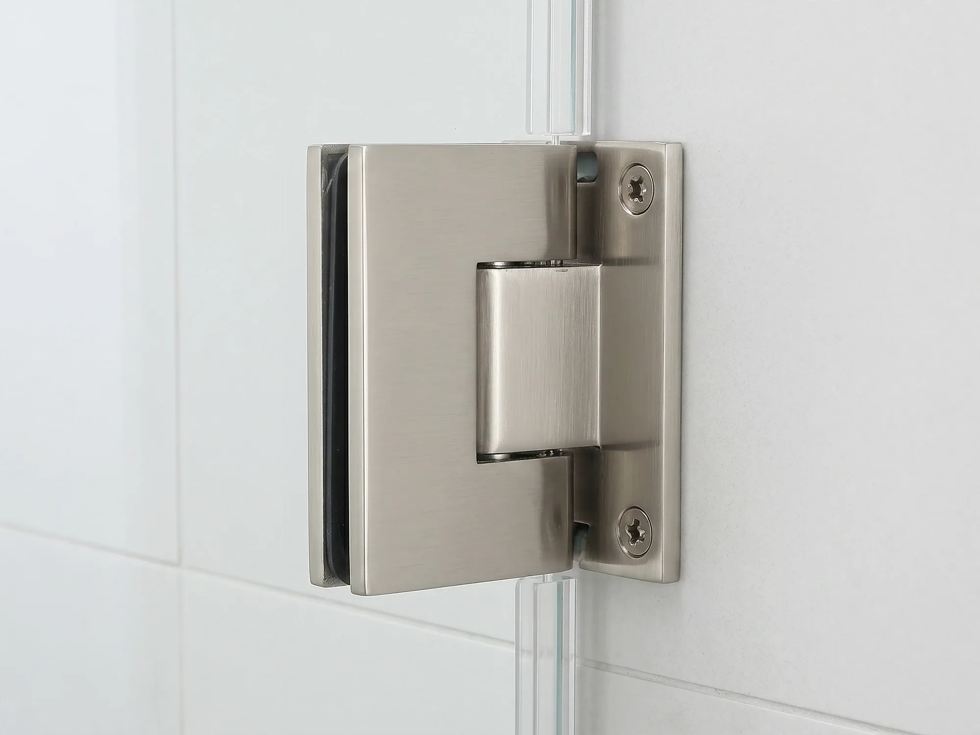 Solid-brass frameless shower door hinge in a brushed nickel finish clamped to 3/8-inch tempered glass