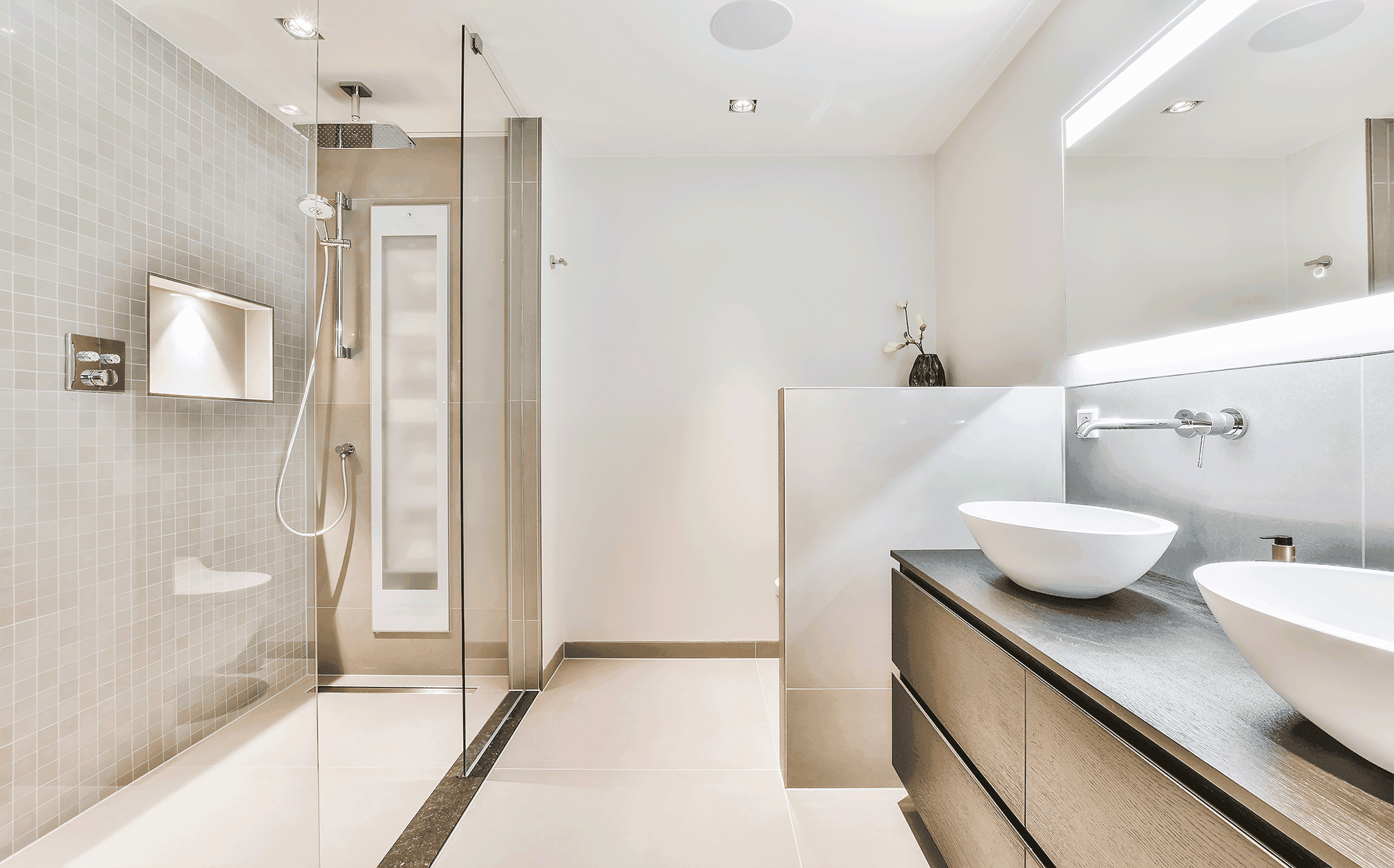 A modern bathroom featuring a walk-in shower with mosaic tiling