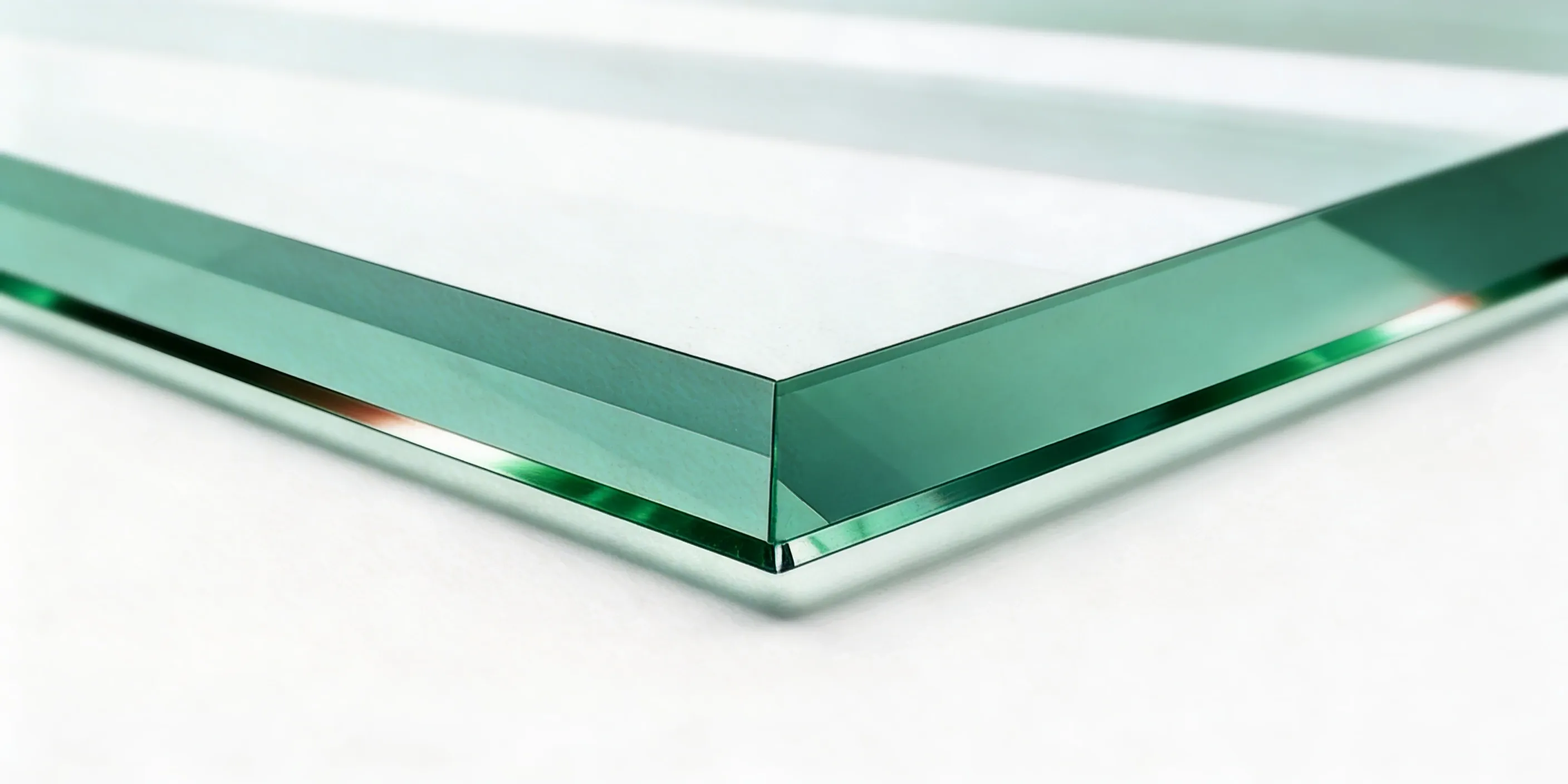 Close-up of a beveled glass edge — angled decorative cut that catches and reflects light elegantly