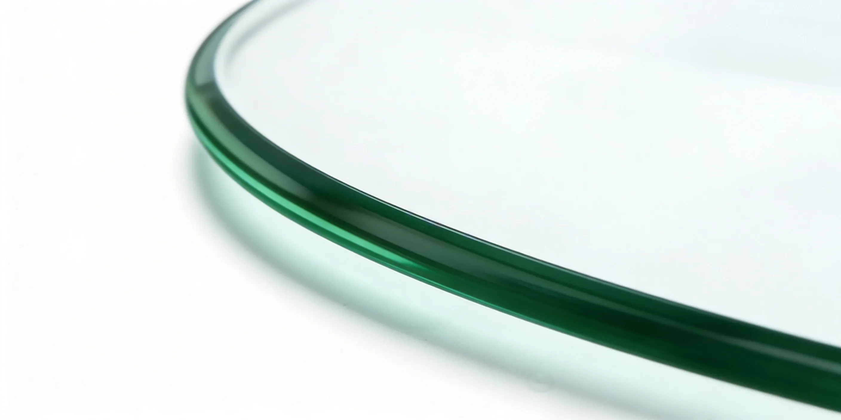 Close-up of a pencil polished glass edge — soft rounded bullnose profile for a smooth, safe finish