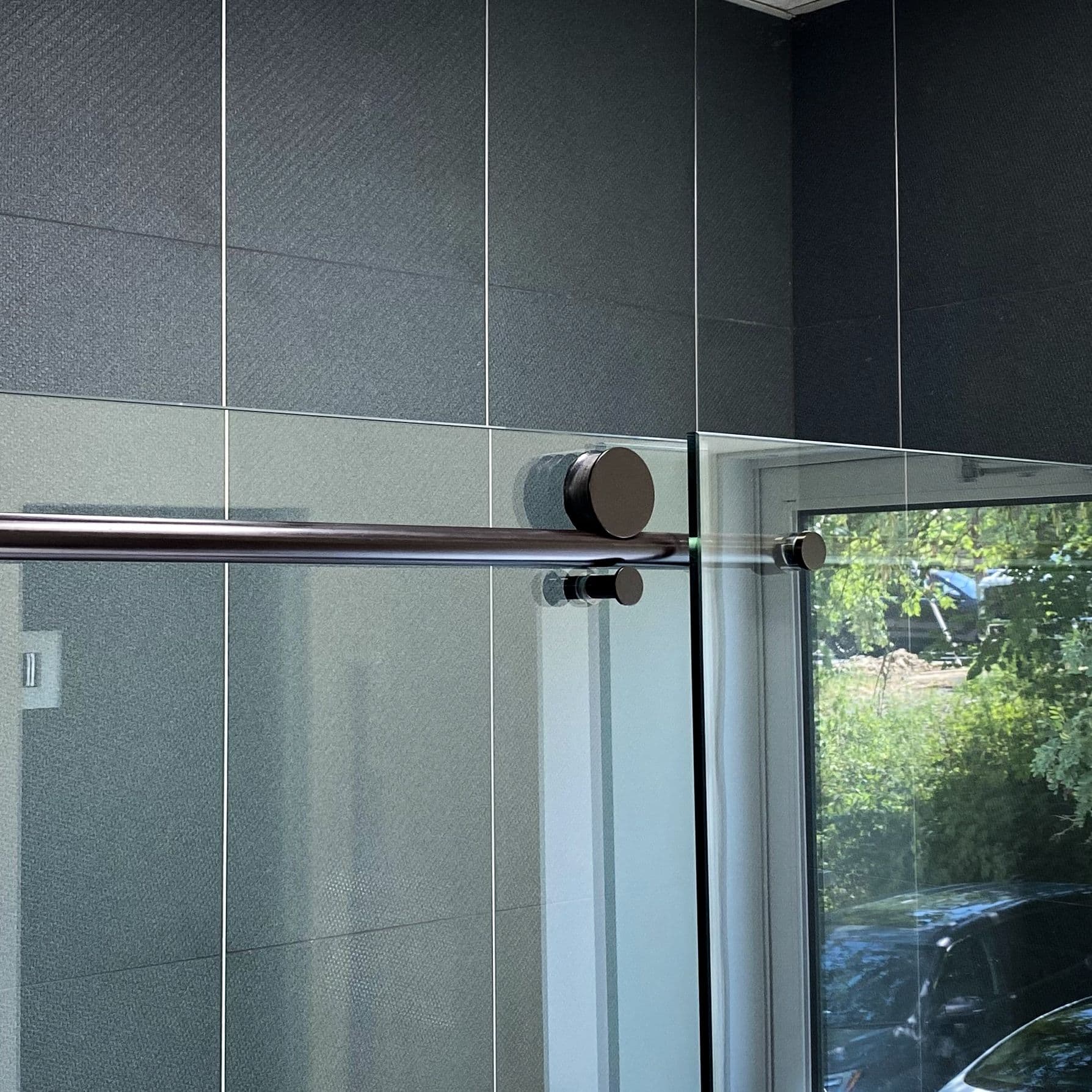 Tempered glass shower doors with sleek hardware, showcasing custom glass design and modern aesthetics.