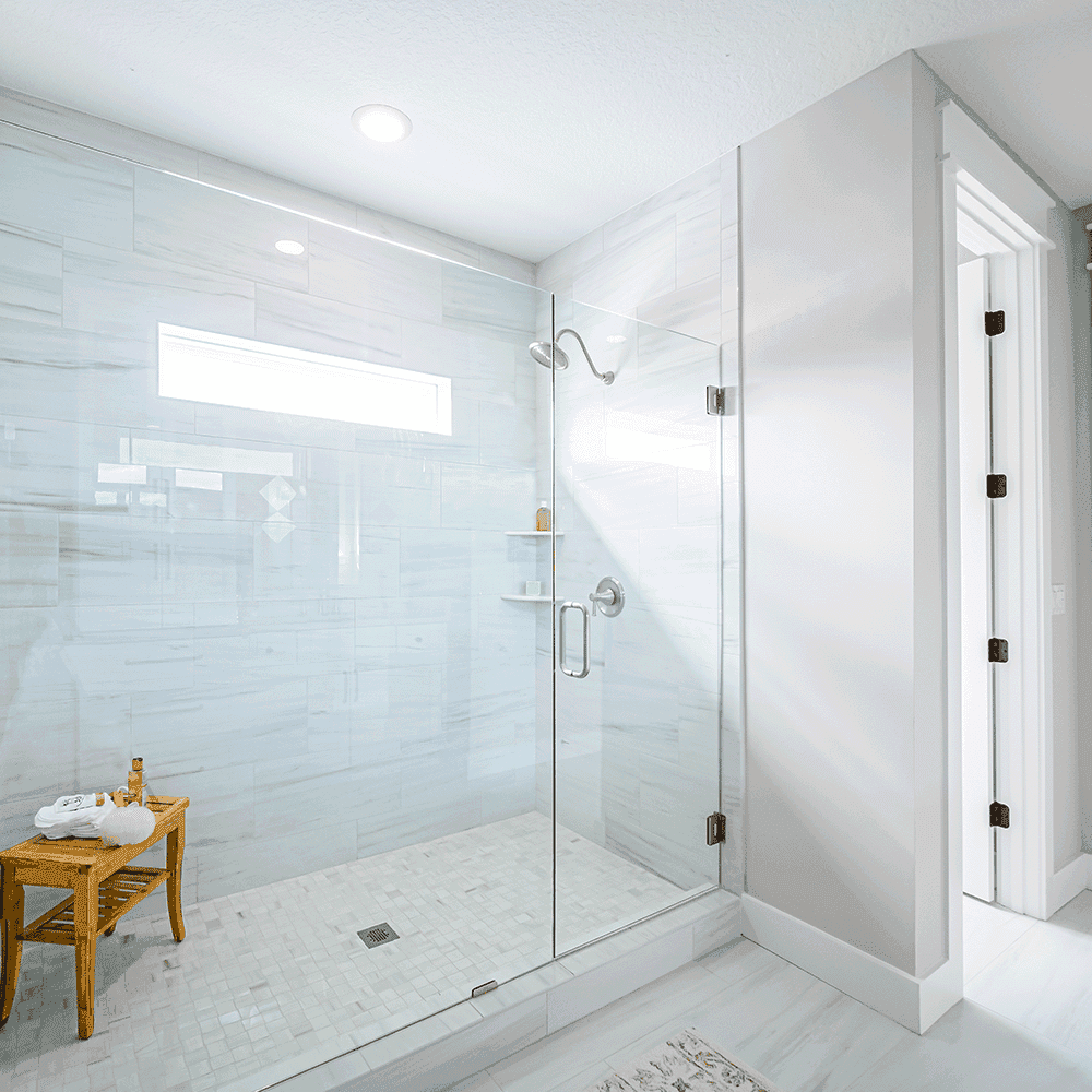 Custom glass shower doors featuring tempered glass, designed for a modern bathroom with a clean aesthetic.