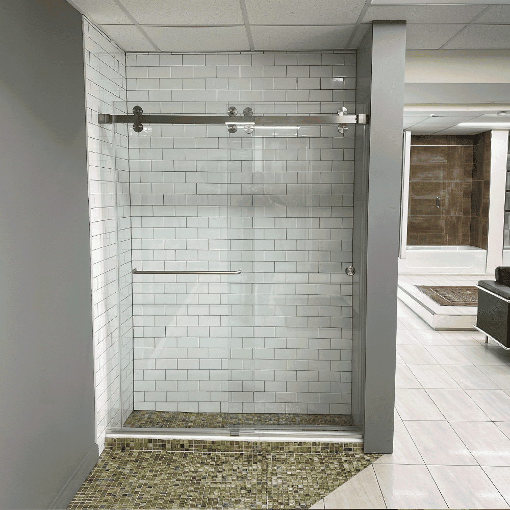 Custom glass shower doors with a sleek design, showcasing tempered glass and a stainless steel track, set in a modern bathroom display.