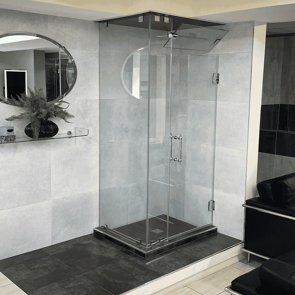 Custom glass shower doors with tempered glass and a sleek beveled edge, featuring an elegant round mirror and modern dÚcor.