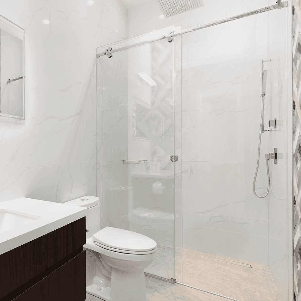 Modern bathroom featuring a sleek glass shower door, minimalistic design, and light marble tiles, showcasing custom glass solutions for enhanced aesthetics and functionality.