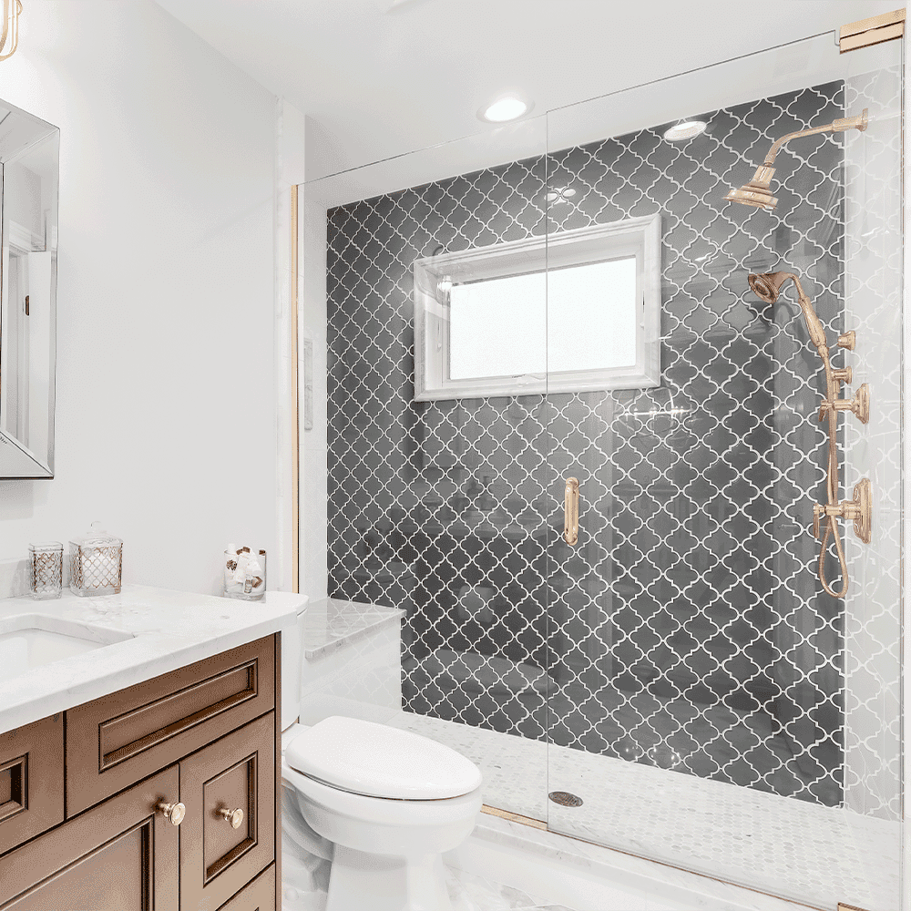 Elegant bathroom featuring custom shower doors, sleek mirrors, and a stunning marble countertop, showcasing tempered glass and a refined beveled glass edge design.