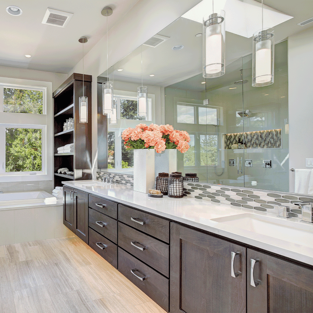 Modern bathroom featuring custom mirrors, stylish shower doors, and a sleek countertop, showcasing tempered glass and a beveled glass edge for an elegant finish.