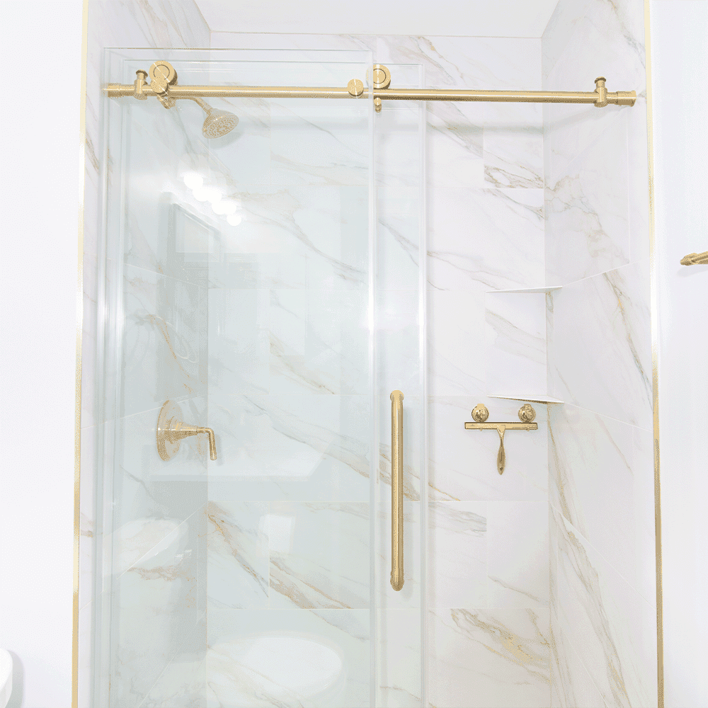 Shower doors featuring custom tempered glass with elegant gold hardware, set against a marble backdrop, ideal for luxury bathroom designs.