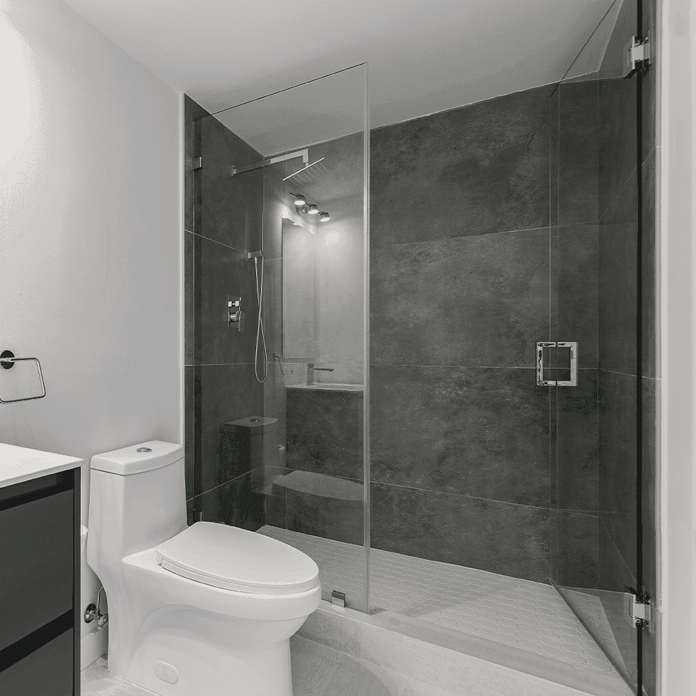 Modern bathroom featuring a shower door made of tempered glass, showcasing custom glass options; highlights a sleek design with a focus on clean lines and functionality.
