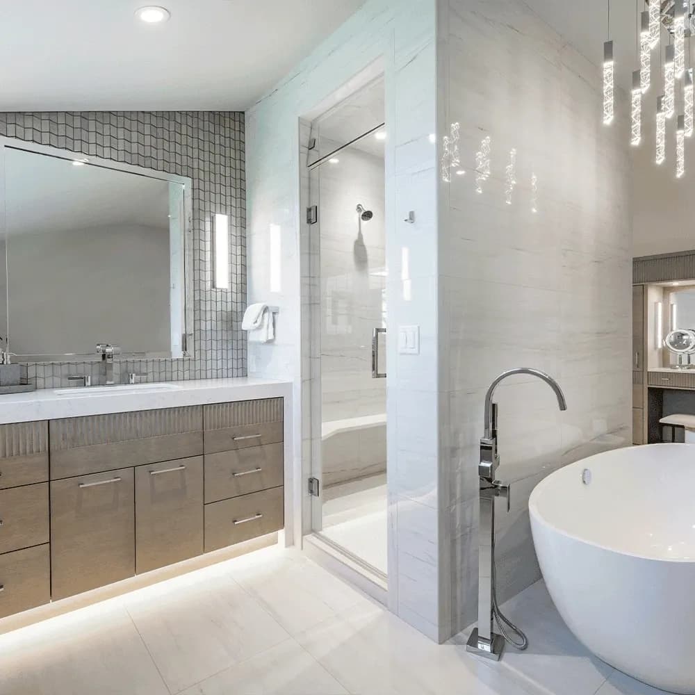 Luxurious bathroom featuring a custom glass shower, freestanding bathtub, modern vanity with wooden accents, and elegant lighting fixtures.