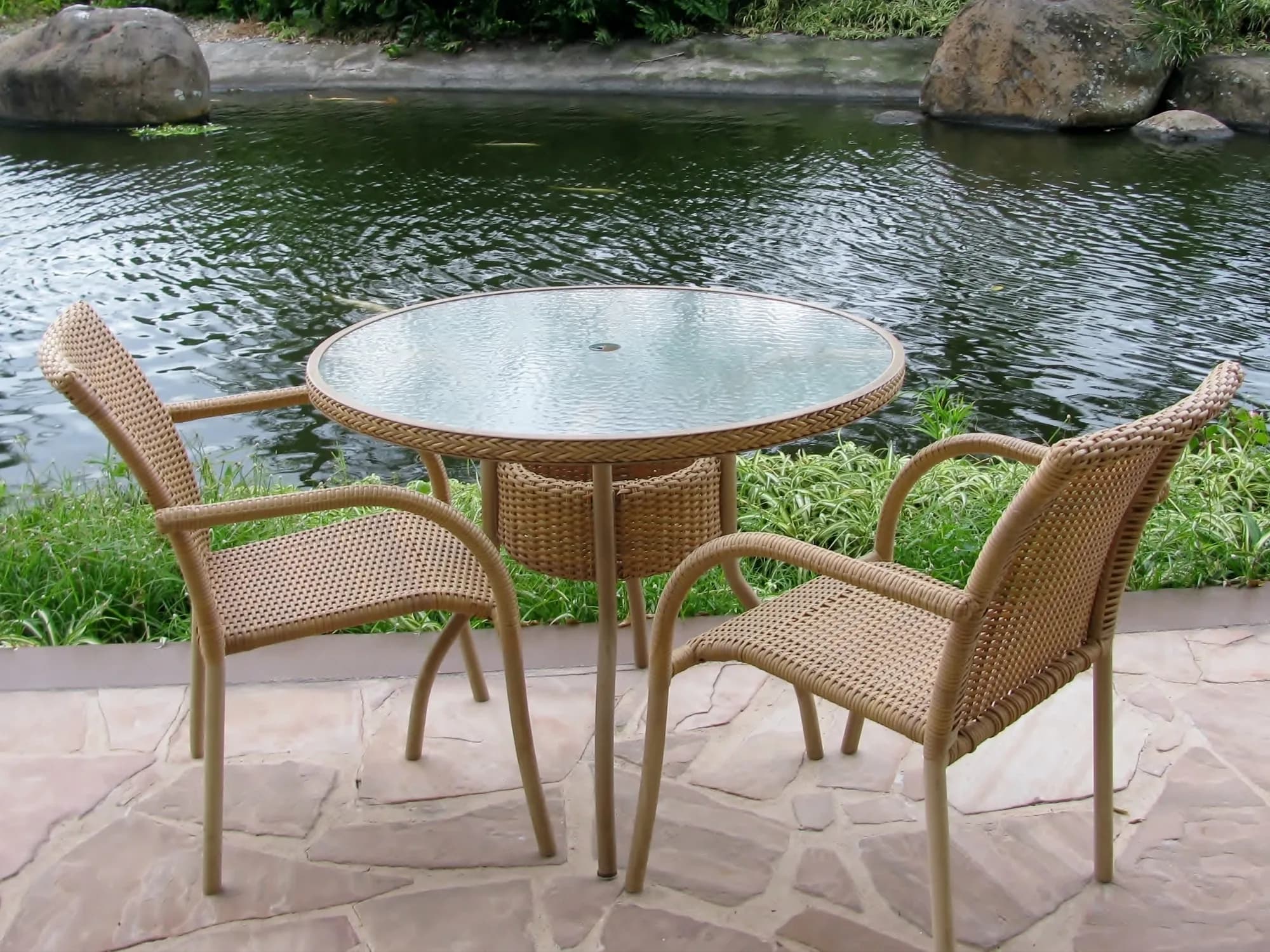 An outdoor wicker patio set with a round