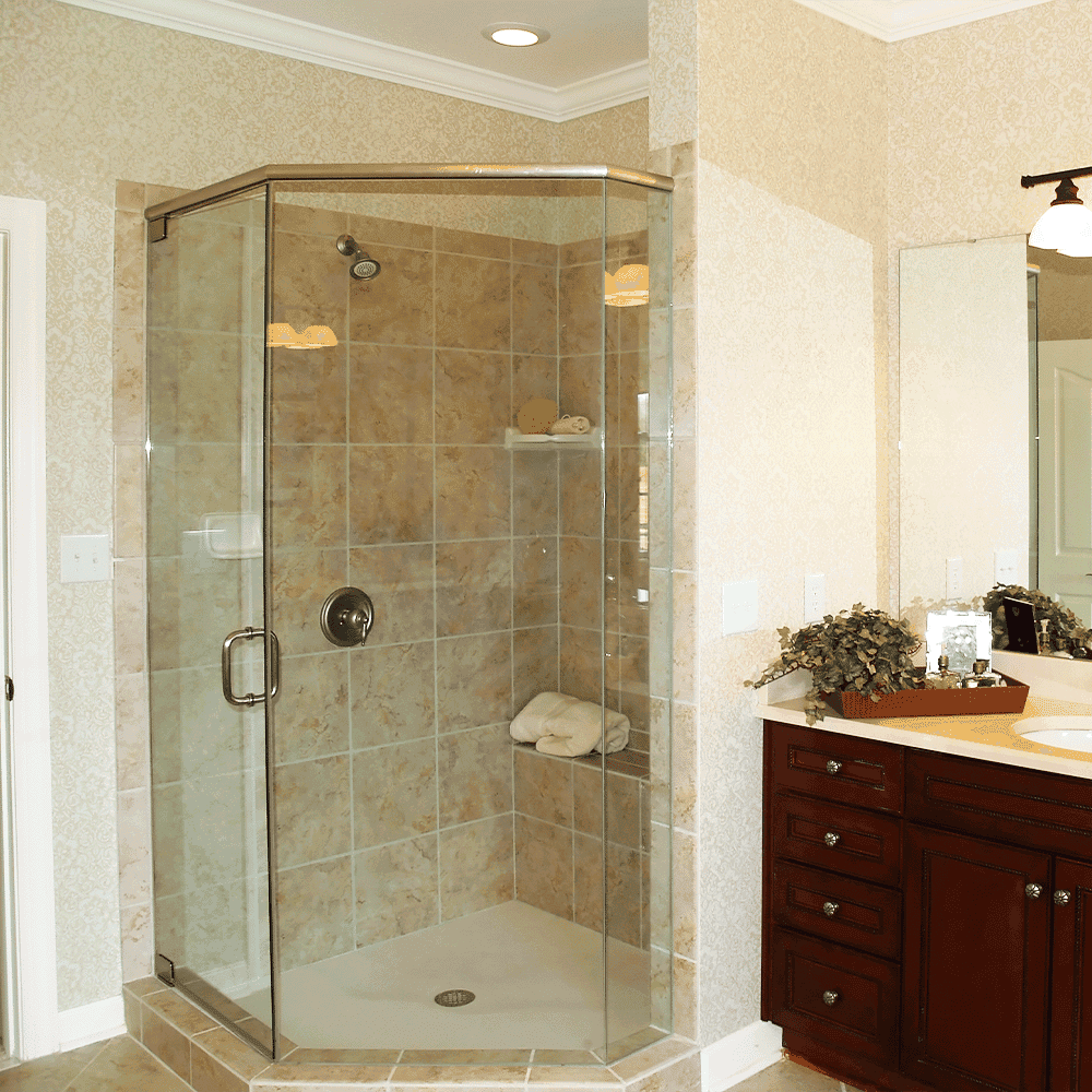 Shower doors featuring custom glass installation with a sleek design, complemented by a contemporary bathroom setting and elegant mirrors.