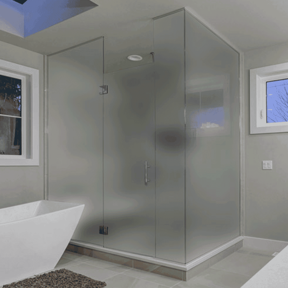 Frosted glass shower doors in a modern bathroom with a freestanding tub, showcasing custom glass solutions and tempered glass design.