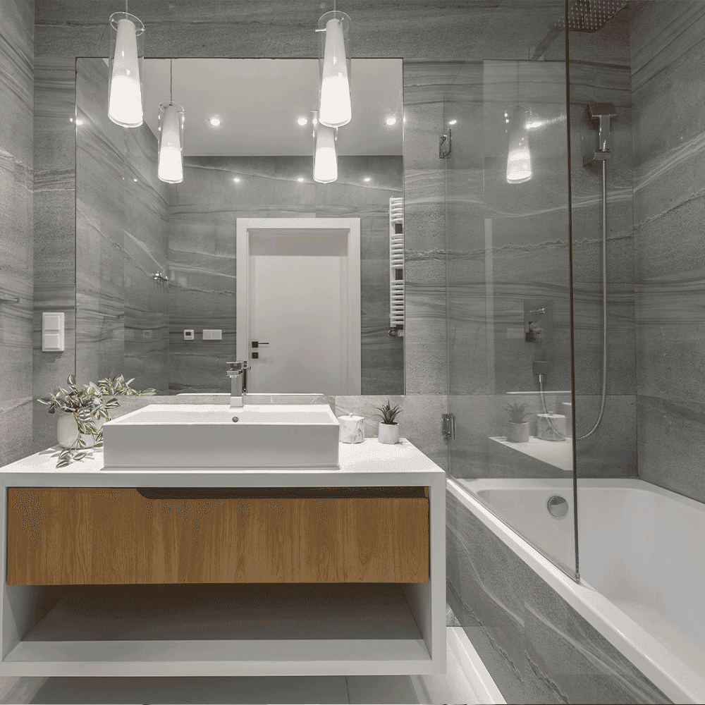 Modern bathroom with custom glass shower doors, sleek table tops, and stylish mirrors, featuring tempered glass and a contemporary design with beveled glass edges.