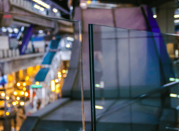 Custom tempered glass panels showcasing bevelled edges, ideal for shower doors, table tops, and mirrors in a modern setting.