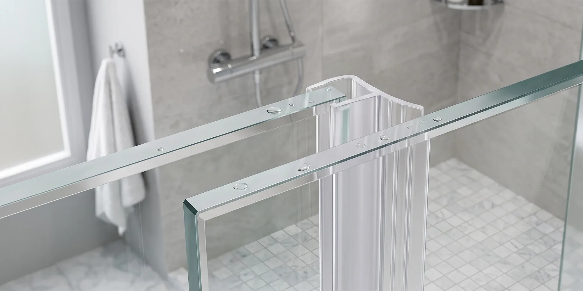 Clear vinyl seal strip being fitted to the edge of a frameless glass shower door