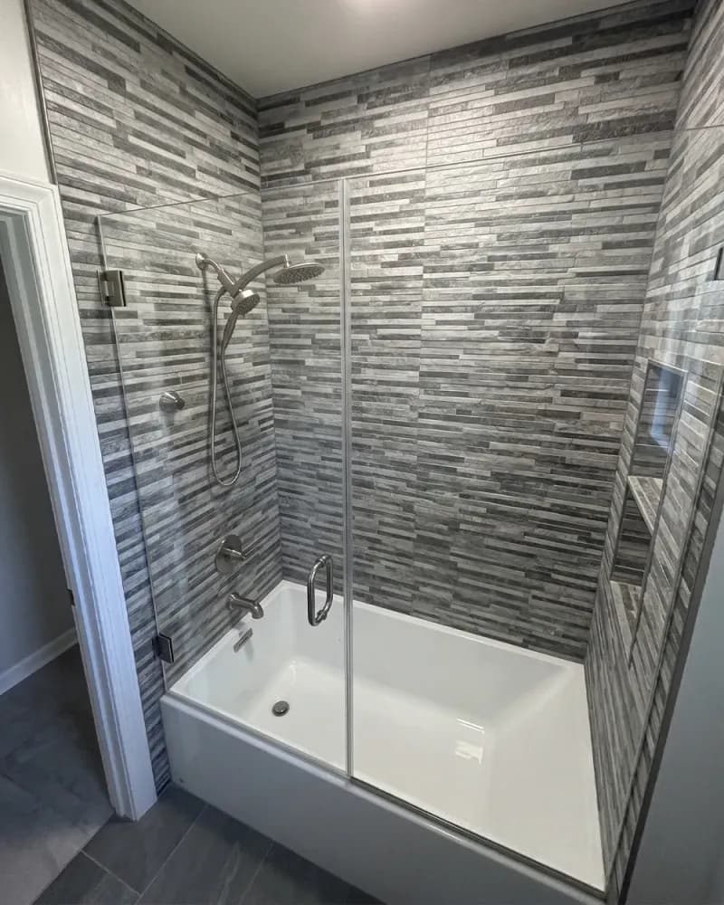 DIY bathtub shower door project with glass tub door installed over a bathtub