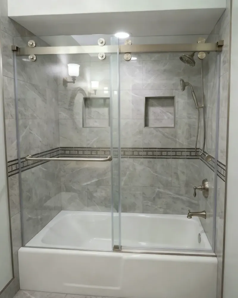 DIY bathtub shower door project showing a finished tub enclosure with glass panels