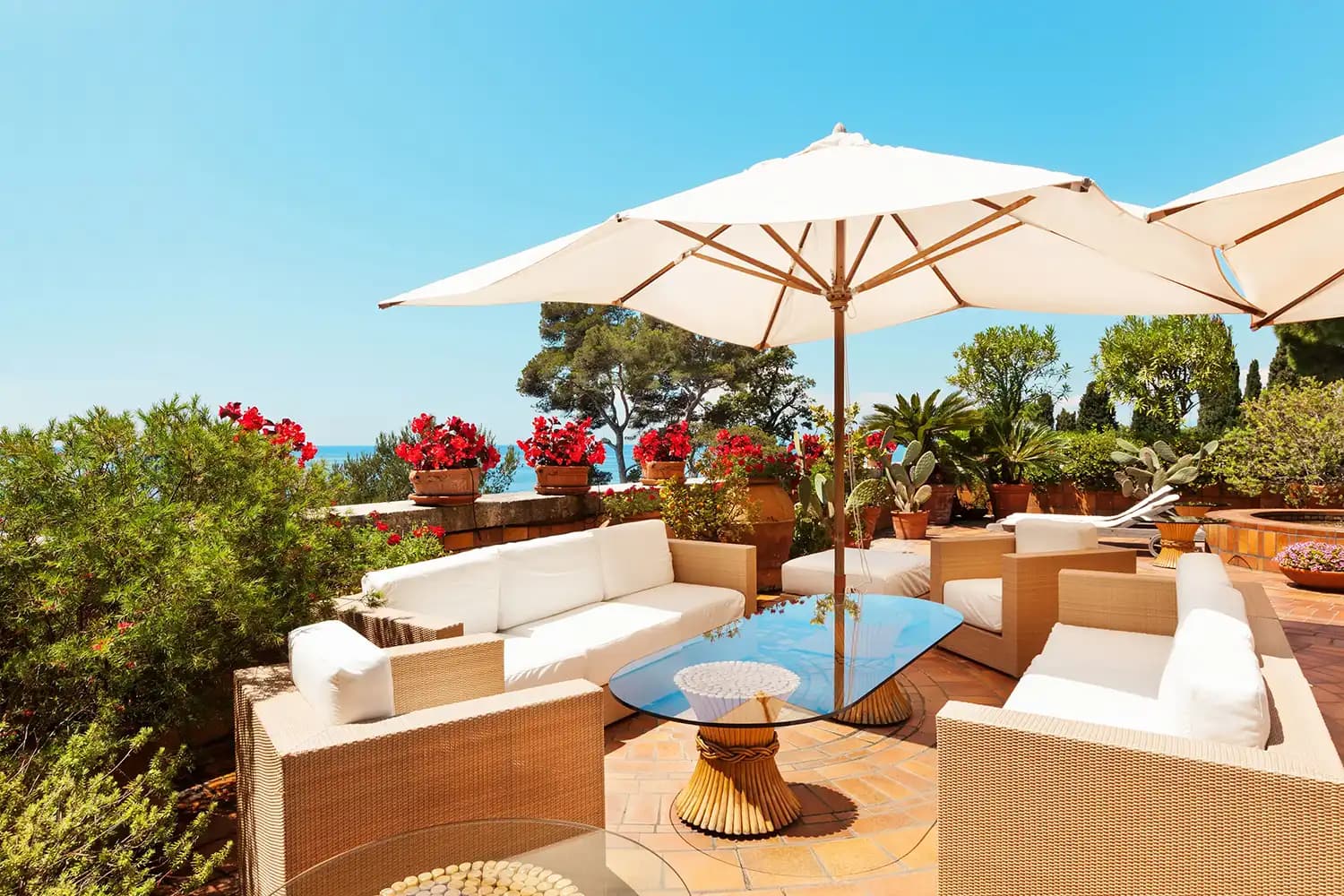 Elegant outdoor seating area featuring a custom glass table top