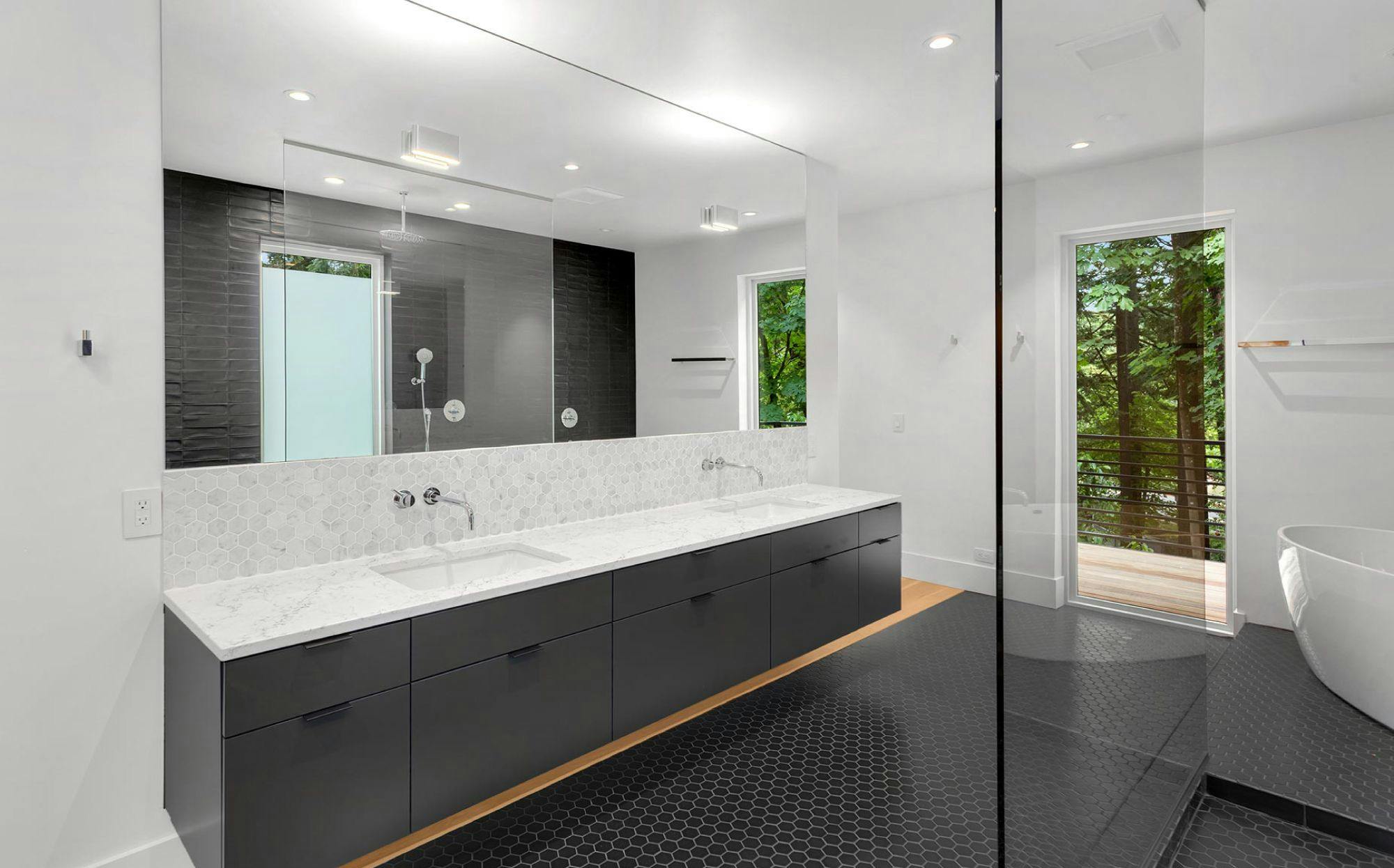shower door and large mirror in white gray bathroom setting