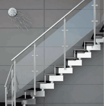 Modern glass railing system on a staircase, featuring clear tempered glass panels and stainless steel fittings, showcasing custom glass solutions.