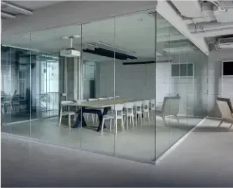 modern office space with custom glass walls, featuring tempered glass and a glass meeting room, highlighting elegant design for commercial spaces