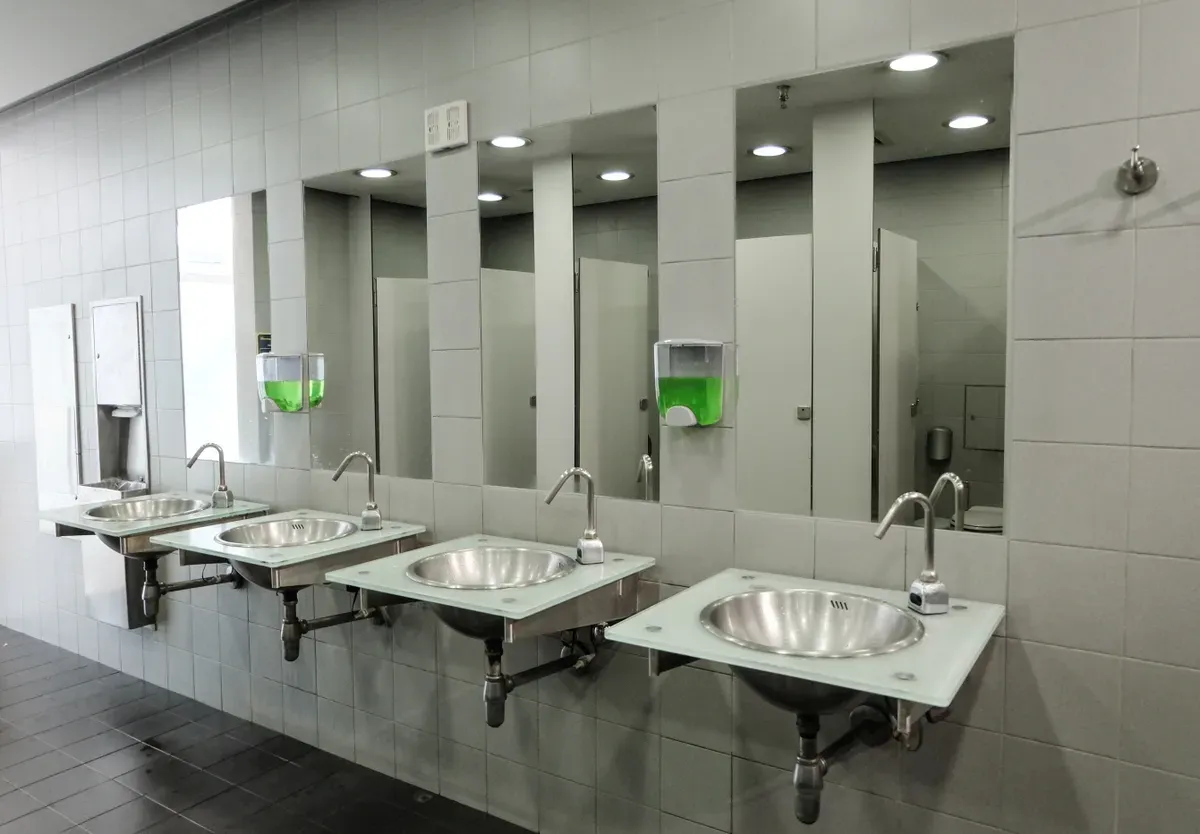 Contemporary restroom featuring custom glass sink tops, tempered glass surfaces, and large mirrors, ideal for showcasing custom glass solutions in shower doors and beveled glass edges.
