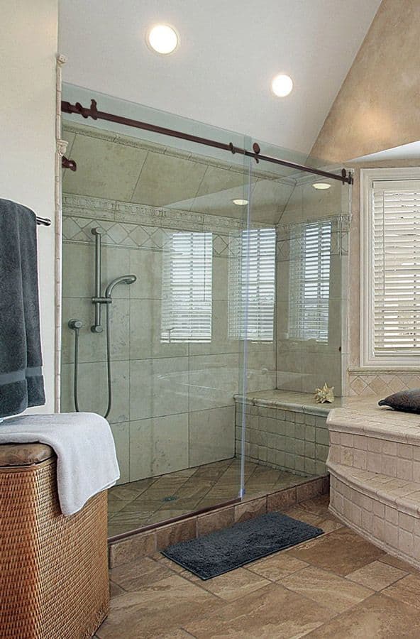 Custom glass shower door with tempered glass, featuring a stylish frame and sleek design, enhancing the modern bathroom ambiance.