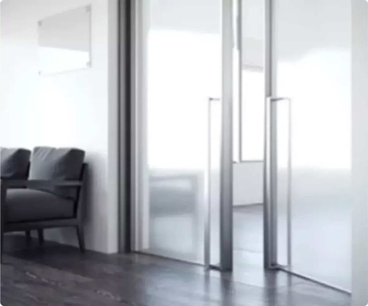 Modern bathroom featuring custom shower doors with frosted glass, a sleek chair, and a wall-mounted mirror, highlighting the elegance of tempered glass design.