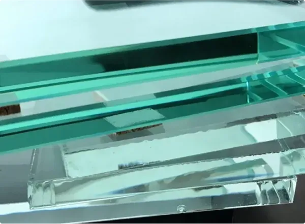 Stack of custom glass pieces showcasing tempered glass and beveled glass edge, ideal for shower doors, table tops, and mirrors.