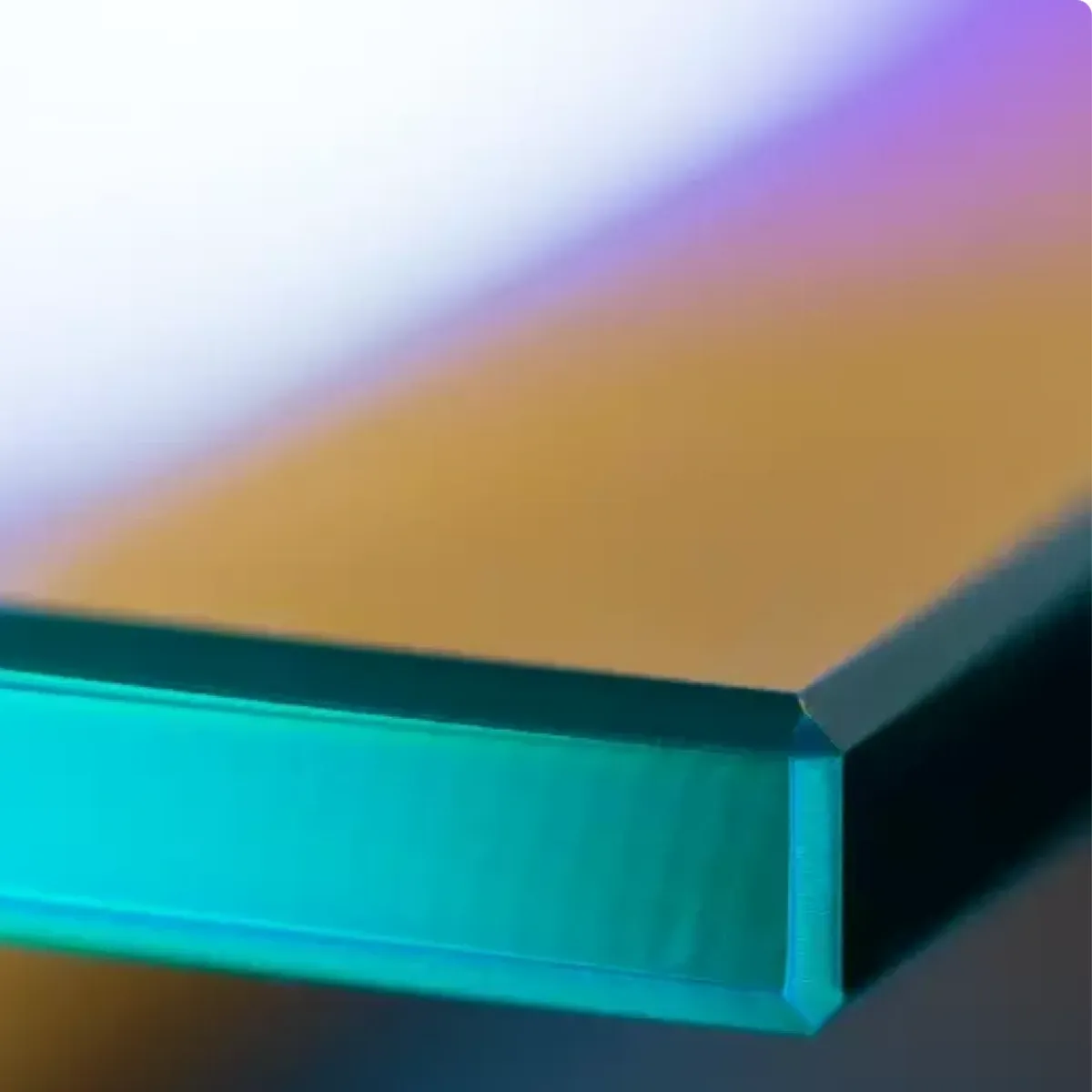 Close-up of a beveled glass edge, showcasing custom glass design suitable for shower doors, table tops, and mirrors, with an emphasis on tempered glass quality.