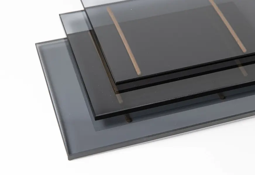 Stacked sheets of tempered glass in varying thicknesses, ideal for custom shower doors, table tops, and mirrors, featuring a sleek beveled glass edge.