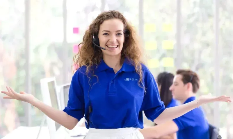 Customer service representative smiling and welcoming clients, showcasing expertise in custom glass solutions including shower doors, table tops, mirrors, tempered glass, and beveled glass edge.